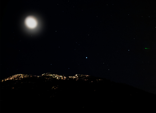 A snowy mountain peak in the moonlight